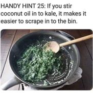 A pan with green leaves and a wooden spoon Description automatically generated
