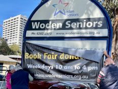 A sign with a banner on it

Description automatically generated