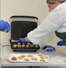 A person putting food on a waffle maker

AI-generated content may be incorrect.