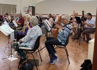 A group of people playing instruments

Description automatically generated