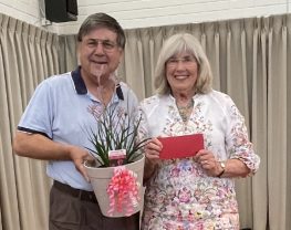 A person and person holding a plant

Description automatically generated