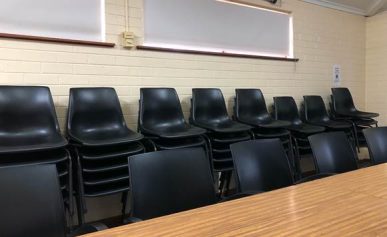 A room with a table and chairs Description automatically generated