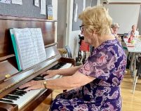 A person playing a piano

Description automatically generated