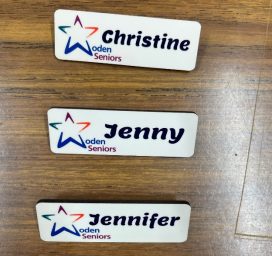 A group of name tags on a wood surface
AI-generated content may be incorrect.