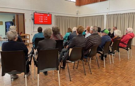 A group of people sitting in chairs

Description automatically generated