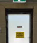 A door with a sign on it

Description automatically generated