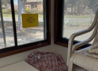 A window with a sign on it

Description automatically generated