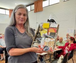 A person holding a box of food

Description automatically generated